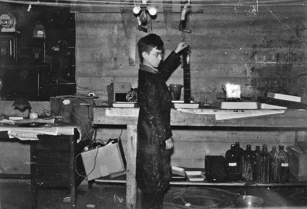 Historical photograph of film being developed in a home darkroom